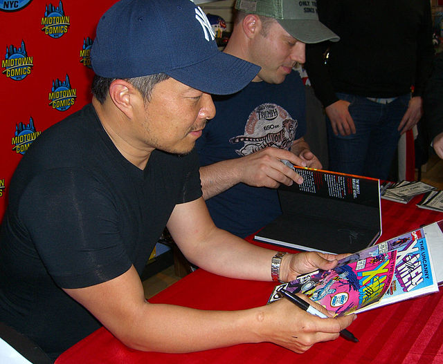 Jim Lee holding some of the 1990s issues of the series on which he rose to stardom as an artist