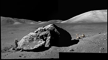 Astronaut Harrison Schmitt working next to Tracy's Rock in the Taurus-Littrow valley on the Apollo 17 mission in 1972. The South massif is visible to the right. AS17-140-21493+AS17-140-21497.jpg