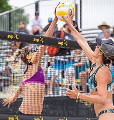 Image 22Two opposing players simultaneously contact the ball above the net with open hands, known as a "joust". The receiving team is entitled to another three contacts. (from Beach volleyball)