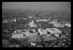 Aerial view of the U.S. Capitol complex in 1964. The O'Neill House Office Building is the caret shaped building in the lower righthand side of the photograph, immediately below the Cannon House Office Building. Air Views of Washington, D.C., the U.S. Capitol, and the Cannon, Longworth and Rayburn House Office Buildings.tif