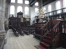 The spacious interior is filled with benches BlaDSCF7296Portuguese Synagogue.jpg
