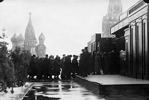 A line of people going into a building