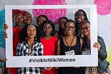 A collective picture with the photo booth participants. Nine African women holding the #VisibleWikiWomen frame.
