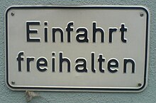 A sign in an older version of DIN Mittelschrift
. Note the different structure of the 'a' and how curved strokes do not thin as they connect, as at the join of the 'h'. DIN Mittelschrift Beispiel.jpg