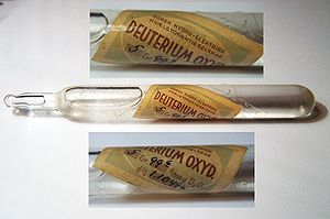 A sealed glass capsule of heavy water, with two detailed photos of its label