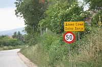 Road sign to Dolno Sonje in Macedonian Cyrillic (above) with romanization (below) Dolno Sonje znak.JPG