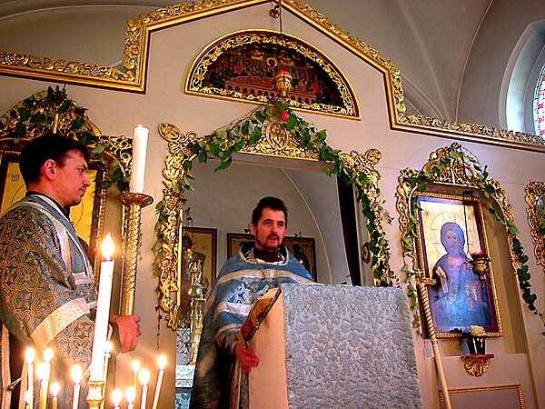 Priest reading the Gospel during the Divine Liturgy.