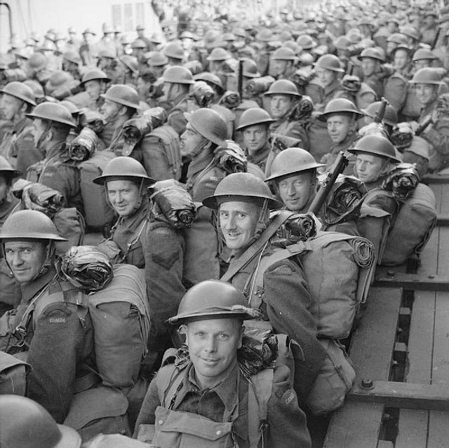Men of the 3rd Canadian Division are carried ashore on a tender, having disembarked from a troopship at Gourock in Scotland, 30 July 1941.