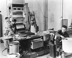 Employees working with the Automatic 16 Inch Powder Stacking Machine at the U.S. Hingham Naval Ammunition Depot during World War II.jpg