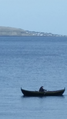 Fisherman in a rowing boat in the Faroe Islands.png