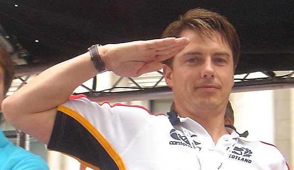 Barrowman saluting in the style of Captain Jack Harkness from a float at the 2007 London Gay Pride parade.