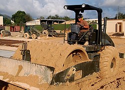 Caterpillar soil compactor equipped with padfoot drum, being used to compact the ground before placing concrete John Deere roller, U.S. Navy, Camp Covington, NMCB-133, 080928-N-1106H-001.jpg