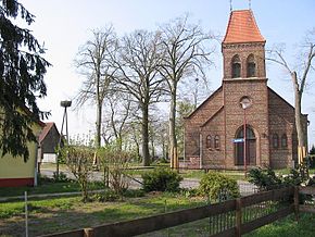 Church in the village of Fahlhorst and nest of stork