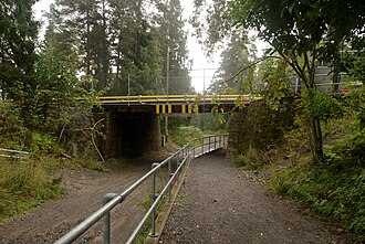 Korketrekkeren as it passes under the Oslo Metro's Holmenkollen Line at Midtstuen Korketrekkeren at Midtstuen.JPG