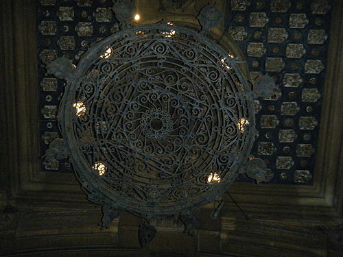 wheel-shaped chandelier at the entrance of the Coppedè quarter (1921) in Rome, Italy