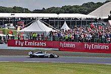 Lewis Hamilton celebrating his 27th career victory in front of the crowd. Lewis Wins! (14899690896).jpg