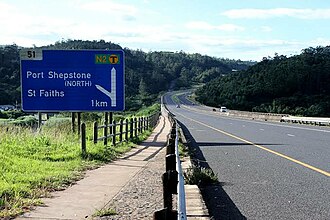 N2 highway north of Port Shepstone with a board sign indicating the off-ramp to Port Shepstone North and St Faith's N2 Port Shepstone (SANRAL).jpg