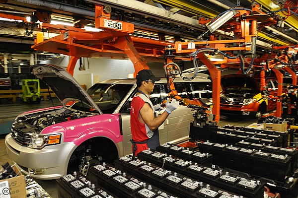 A worker installing car batteries at Ford's Oakville Assembly. The automotive industry is a major sector of the Golden Horseshoe's economy.