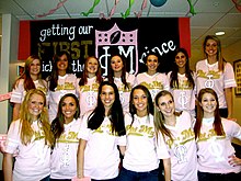 Members of Phi Mu Sorority on their Bid Day. Many members will pay for extra amenities on Bid Day. Phi Mu (6731893681).jpg