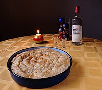 Rolled pie (or rolled burek) served with the national drink rakia Pita savijaca (Rolled pie, Serbian cuisine).jpg