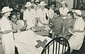 Red Cross volunteers handing out cigarette packets to patients, ca. 1945 (29489285600).jpg