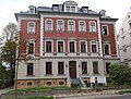 Apartment building in open development with front garden