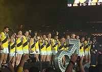 Richmond players celebrate on stage following the 2017 AFL Grand Final Richmond celebrations 2 GF17.jpg