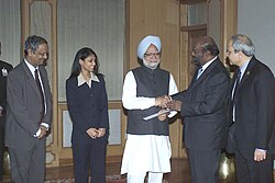 Shri Shiv Nadar and Ms Roshni Nadar presenting a cheque of Rs. 4 crore to the Prime Minister, Dr. Manmohan Singh, towards the Prime Minister's National Relief Fund in New Delhi on January 17, 2005.jpg
