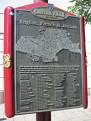 Sign explaining street names of Saint Helier in English, French and Jèrriais
