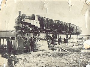 Decauville locomotive with passenger train on a bridge