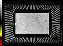 Gating was then changed to include only depth of the die attach material that attaches the silicon die to the die paddle. The die, the die paddle, and other features above and below the die attach depth are ignored. In the resulting acoustic, shown above slightly magnified, the red areas are voids (defects) in the die attach material. Sonoscanart6.jpg