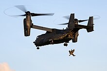 CV-22B on training exercise of the Special Tactics Squadron on a hoist, in the UK in 2021 Special tactics operators assigned to the 321st Special Tactics Squadron tandem hoist into a CV-22B Osprey during a training exercise near RAF Mildenhall, United Kingdom, April 15, 2021.jpg