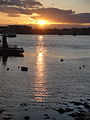 The sun setting at Portsmouth Harbour, Portsmouth, Hampshire in March 2012. It is seen from Portsmouth, with the view towards Gosport.