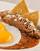 Totopo chips on refried beans Totopos.JPG