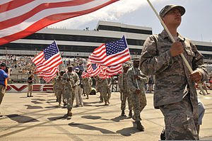 Soldiers and airmen from the Delaware National Guard during the opening ceremony for the 2013 FedEx 400 NASCAR race U.S. Soldiers and Airmen with the Delaware National Guard carry U.S. flags in the opening ceremony for NASCAR's FedEx 400 at the Dover International Speedway in Dover, Del., June 2, 2013 130602-Z-DL064-079.jpg