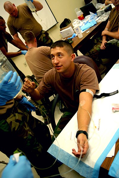 File:US Navy 081203-N-3674H-278 Ensign Christopher Waldrop receives saline solution via intravenous therapy.jpg