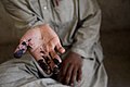 US Navy 090821-M-0440G-093 An Afghanistan presidential election worker displays ink on his hand from counting and organizing election ballots at a local school in the Nawa District.jpg