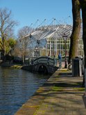 View from the canal border of the Nieuwe Herengracht at the newest greenhouse of the Botanical Garden in Amsterdam; free photo by Fons Heijnsbroek, 27 March 2022