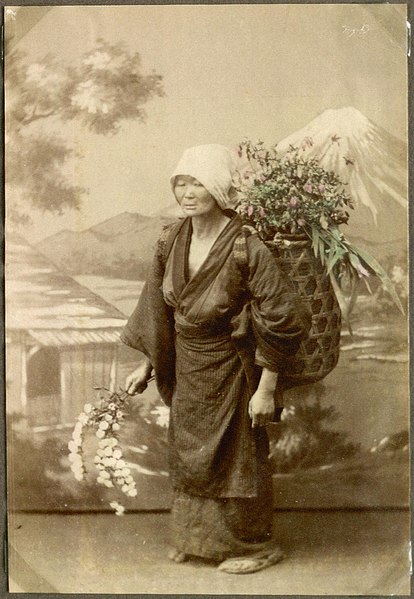 File:Woman with a basket on her back, selling flowers, Japan. (10797185116).jpg