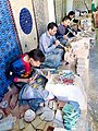 Artisan workers chipping zellige pieces, Fez, Morocco.