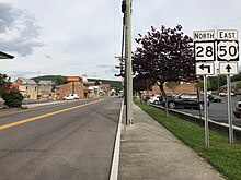 US 50 and WV 28 run concurrently for short stretch within and southwest of Romney 2019-05-16 17 53 35 View east along U.S. Route 50 and north along West Virginia State Route 28 (Main Street-Northwestern Pike) at Bolton Street in Romney, Hampshire County, West Virginia.jpg