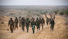 Kenyan soldiers and fighters of the Ras Kamboni Brigades, a Somali government-allied militia, near Kismayo, Somalia, 2012 AMISOM Kismayo Advance 15 (8049962361).jpg