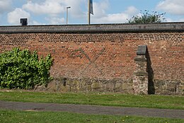 A photograph of Abbot Penny's Wall: part of the abbey precinct wall built in brick around the turn of the 16th century