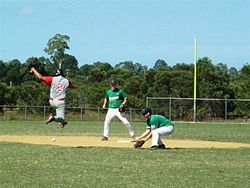 A runner jumping over a ball to avoid an offensive interference Avoid Interference.jpg