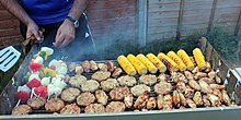 A British barbecue including chicken kebabs, marinated chicken wings, sweetcorn, and an assortment of vegetables British Barbecue.jpg
