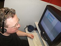 A call centre worker confined to a small workstation/booth Callcentreterminal.JPG