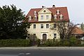 Residential house with northeastern outbuilding and garden shed