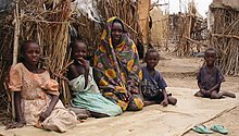 Internally displaced persons' camp Darfur IDPs children sitting.jpg