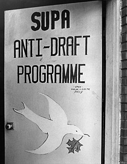 Street door to the office of the Student Union for Peace Action's Anti-Draft Programme, on busy Spadina Avenue in Toronto, August 1967. Draft dodger counseling office.jpg