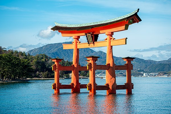 The torii gateway to the Itsukushima Shrine in Hiroshima Prefecture, Japan, one of the most famous examples in the country. Torii mark the entrance to